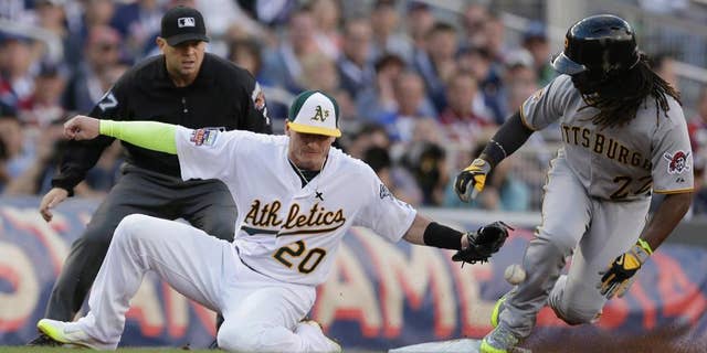 National League outfielder Andrew McCutchen, of the Pittsburgh Pirates, steals third base as American League Josh Donaldson, of the Oakland Athletics, tries to make the tag during the first inning of the MLB All-Star baseball game, Tuesday, July 15, 2014, in Minneapolis. (AP Photo/Jeff Roberson)