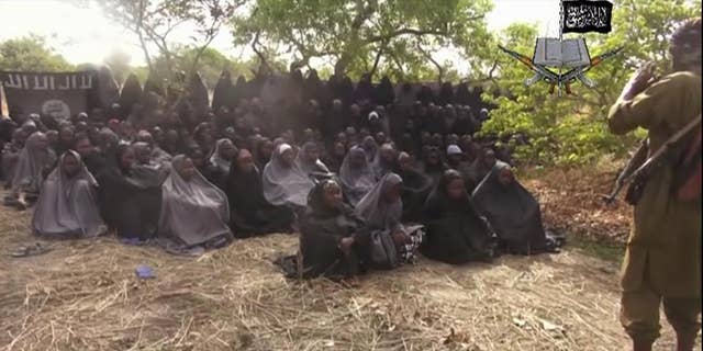FILE - This Monday, May 12, 2014, file image taken from video by Nigeria's Boko Haram terrorist network, shows the alleged missing girls abducted from the northeastern town of Chibok.  Islamic extremists in Nigeria have seized Chibok, forcing thousands of residents to flee the northeastern town from which the insurgents kidnapped nearly 300 schoolgirls in April, a local official said Friday, Nov. 14, 2014. (AP Photo/File)