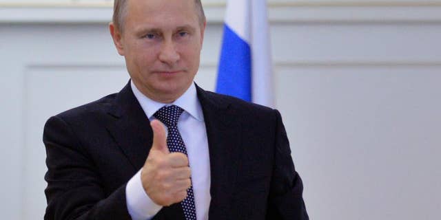 Russian President Vladimir Putin gives thumbs up during a live video link with Plesetsk Cosmodrome, as he watches a launch of Angara-A5 rocket booster in Moscow, Russia, on Tuesday, Dec. 23, 2014. (AP Photo/RIA Novosti, Alexei Druzhinin, Presidential Press Service)