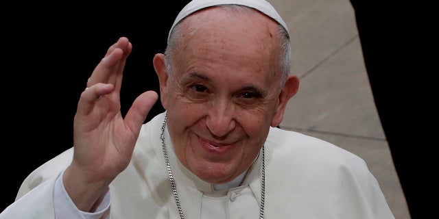 Pope Francis waves during his visit to the parish church of San Paolo della Croce, in Corviale neighborhood, Rome, Sunday, April 15, 2018.