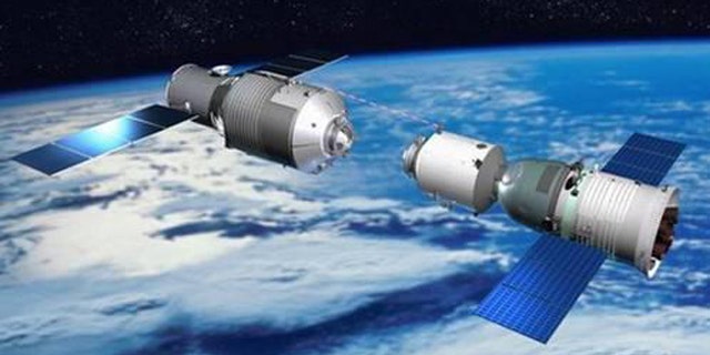 This illustration depicts a Chinese Shenzhou vehicle approaching the Tiangong 1 space lab during orbital rendezvous and docking tests, a precursor for space station construction.