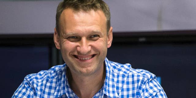 FILE - In this file photo taken on Wednesday, July 29, 2015, Russian opposition activist Alexei Navalny smiles before a broadcast at the Echo Moskvy (Echo of Moscow) radio station in Moscow. Russia's Supreme Court has sent a criminal case of the opposition leader for retrial following a ruling of the European Court of Human Rights. (AP Photo/Pavel Golovkin, FILE)