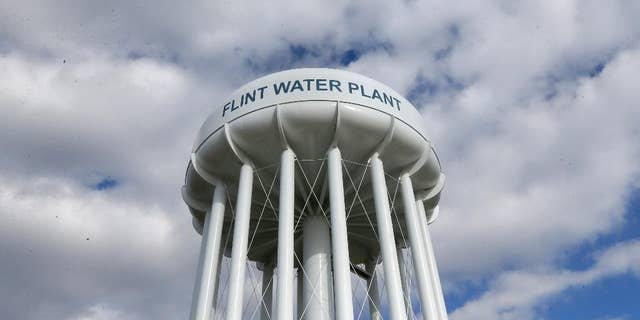In this photo taken March 21, 2016, the Flint Water Plant water tower is seen in Flint, Mich. President Barack Obama next week will make his first trip to Flint, Mich. since the impoverished city was found to have lead-tainted drinking water, the White House said Wednesday, April 27, 2016. (AP Photo/Carlos Osorio)