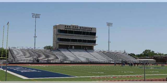 FILE - In this April 28, 2016, file photo, middle schoolers use the field in Ron Poe Stadium in McKinney, Texas. Voters in McKinney Independent School District approved a bond issue Saturday, May 7, 2016, to build a new high school football stadium. (AP Photo/LM Otero, File)