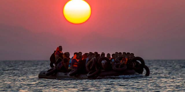 Refugeess on a dinghy approach the southeastern island of Kos, Greece, in August 2015.