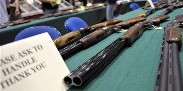 File: June 19, 2010: Assorted shotguns are displayed on a table at a gun and knife show in White Plains, N.Y.,