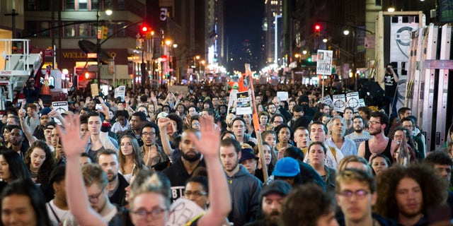 Protestors march up Seventh Avenue towards Times Square after the announcement of the grand jury decision not to indict police officer Darren Wilson in the fatal shooting of Michael Brown, an unarmed 18-year-old black man, Monday, Nov. 24, 2014, in New York. (AP Photo/John Minchillo)