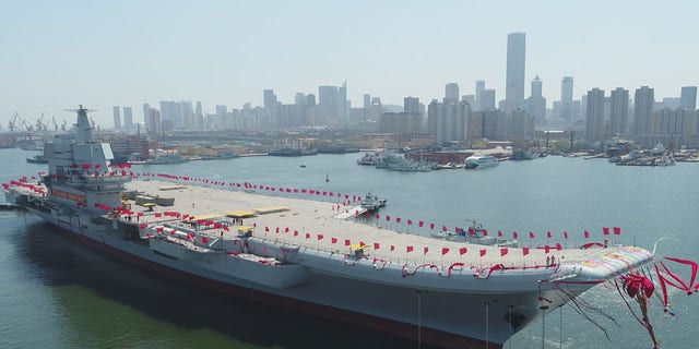 In this photo released by China's Xinhua News Agency, a newly-built aircraft carrier is transferred from dry dock into the water at a launch ceremony at a shipyard in Dalian in northeastern China's Liaoning Province, Wednesday, April 26, 2017.