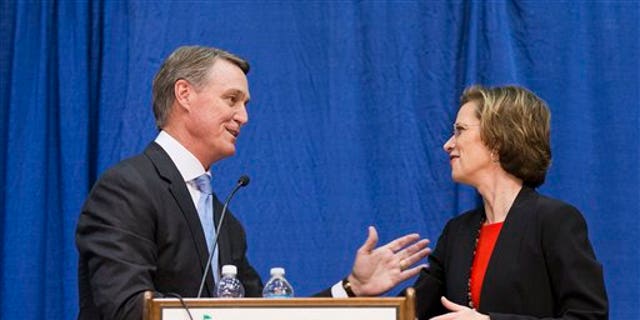 Georgia Democratic candidate for U.S. Senate Michelle Nunn, right, shakes hands with Republican candidate David Perdue following a debate, Tuesday, Oct. 7, 2014, in Perry, Ga. (AP Photo/David Goldman)