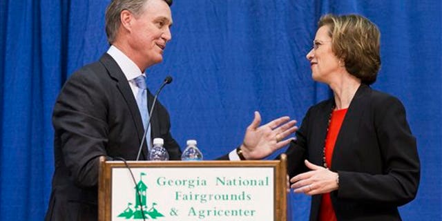 Georgia Democratic candidate for U.S. Senate Michelle Nunn, right, shakes hands with Republican candidate David Perdue following a debate, Tuesday, Oct. 7, 2014, in Perry, Ga. (AP Photo/David Goldman)