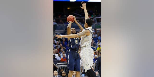 Colorado forward Dustin Thomas (13) defends Pittsburgh forward Lamar Patterson (21) during the second half in a second-round game in the NCAA college basketball tournament Thursday, March 20, 2014, in Orlando, Fla. (AP Photo/John Raoux)