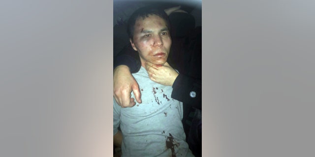 In this file photo, a man believed to be the gunman who killed dozens at an Istanbul nightclub films himself as he wanders nearby to Istanbul's Taksim square