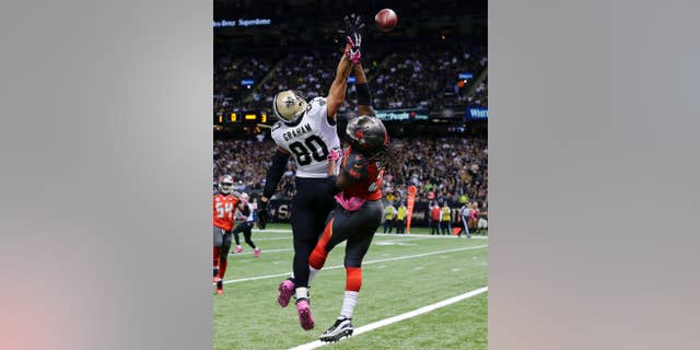 New Orleans Saints tight end Jimmy Graham (80) leaps for an overthrown pass as Tampa Bay Buccaneers strong safety Mark Barron defends in the first half of an NFL football game in New Orleans, Sunday, Oct. 5, 2014. (AP Photo/Bill Haber)