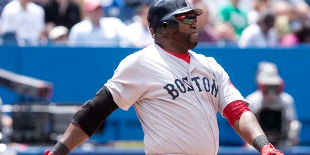 Boston Red Sox's David Ortiz hits a three-run home run in the fifth inning of MLB baseball game action against the Toronto Blue Jays in Toronto, Sunday, June 12, 2011. (AP Photo/The Canadian Press, Darren Calabrese)