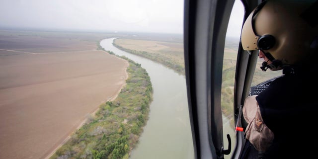 In this Feb. 24, 2015 photo, U.S. Customs and Border Protection Air and Marine agents patrol along the Rio Grande on the Texas-Mexico border near Rio Grande City, Texas. Drowning deaths have spiked since last fall as a surge of law enforcement along the Mexico border prompts immigrants, desperate to avoid detection by a surge of law enforcement, to choose more dangerous and remote crossings into South Texas. (AP Photo/Eric Gay)