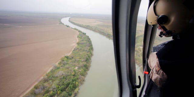 In this Feb. 24, 2015 photo, U.S. Customs and Border Protection Air and Marine agents patrol along the Rio Grande on the Texas-Mexico border near Rio Grande City, Texas. Drowning deaths have spiked since last fall as a surge of law enforcement along the Mexico border prompts immigrants, desperate to avoid detection by a surge of law enforcement, to choose more dangerous and remote crossings into South Texas. (AP Photo/Eric Gay)