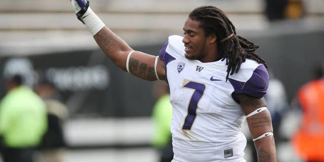 Washington running back Shaq Thompson waves to the crowd as he heads off field after Washington's 38-23 victory over Colorado in an NCAA college football game in Boulder, Colo., on Saturday, Nov. 1, 2014. (AP Photo/David Zalubowski)