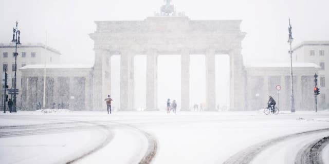 The Brandenburg gate can be seen through the window of a car during snowfall in Berlin, Germany, Wednesday, Jan. 11, 2017. (Sophia Kembowski/dpa via AP)