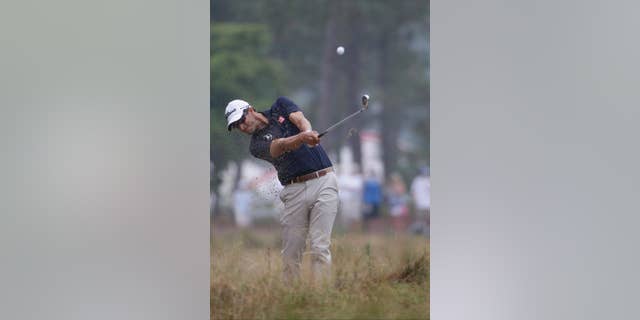 Adam Scott, of Australia, hits from the natural area on the 12th hole during the second round of the U.S. Open golf tournament in Pinehurst, N.C., Friday, June 13, 2014. (AP Photo/David Goldman)