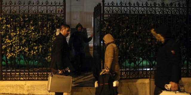 Police investigators enter the house of the Russian consul Andrei Malanin in Athens, Monday, Jan. 9, 2017. Greek police say the Russian consul in Athens has been found dead in his flat in the Greek capital, but there are no immediate indications of foul play.(Costas Baltas/InTime News via AP)