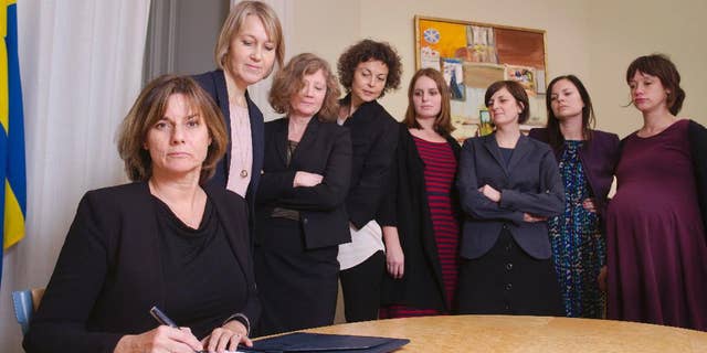 In this handout photo provided by the Swedish Government, Sweden's Deputy Prime Minister Isabella Lovin, left, signs a proposal for the Scandinavian country's new climate law in Stockholm, Friday, Feb. 3, 2017. Sweden's Deputy Prime Minister has posted on Facebook an all-woman photo including herself signing a proposal for the Scandinavian country's new climate law - a photo many online commentators have taken as a direct swipe at Donald Trump. (Johan Schiff/Swedish Government via AP)