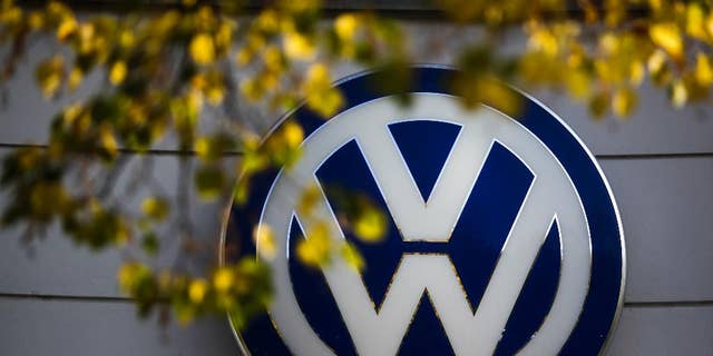 FILE - This Oct. 5, 2015 file photo shows the Volkswagen logo at the building of a company retailer in Berlin, Germany. Volkswagen almost inevitably will have to compensate owners of diesel cars equipped with emissions-rigging software. Some legal experts say the automaker could be forced to buy back the cars altogether. (AP Photo/Markus Schreiber, File)