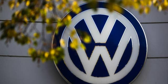 FILE - This Oct. 5, 2015 file photo shows the Volkswagen logo at the building of a company retailer in Berlin, Germany. Volkswagen almost inevitably will have to compensate owners of diesel cars equipped with emissions-rigging software. Some legal experts say the automaker could be forced to buy back the cars altogether. (AP Photo/Markus Schreiber, File)