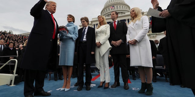 President Donald Trump takes the oath of office as his wife, Melania, holds the Bible alongside his children, Barron, Ivanka, Eric and Tiffany, on Capitol Hill, Jan. 27, 2017.