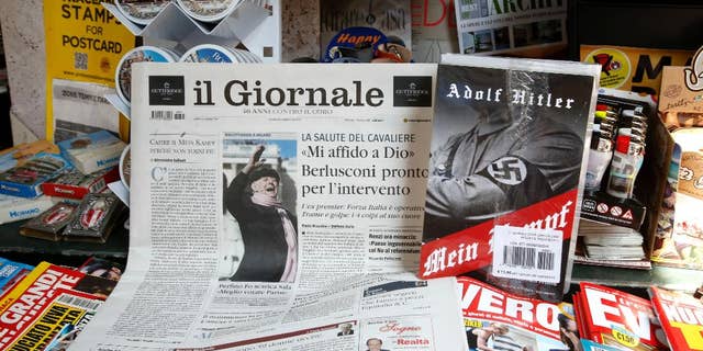 Il Giornale newspaper is seen on sale in a newsstand with Hitler's "Mein Kampf", in Rome Saturday, June 11, 2016. The conservative Milan daily Il Giornale
has published Hitler’s political manifesto ‘’Mein Kampf,’’ angering Italy’s premier and the tiny Jewish community. (AP Photo/Fabio Frustaci)