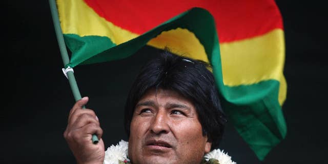 FILE - In this Jan. 22, 2009 file photo, Bolivia's President Evo Morales waves a Bolivian flag during a rally in support of the proposed new constitution in Cochabamba, Bolivia. Morales inaugurated a $7 million museum on Feb. 2, 2017 in his native village of Orinoca, coined the Museum of the Democratic and Cultural Revolution. Bolivia’s political opposition has dubbed it the "Evo Museum." (AP Photo/Dado Galdieri, File)