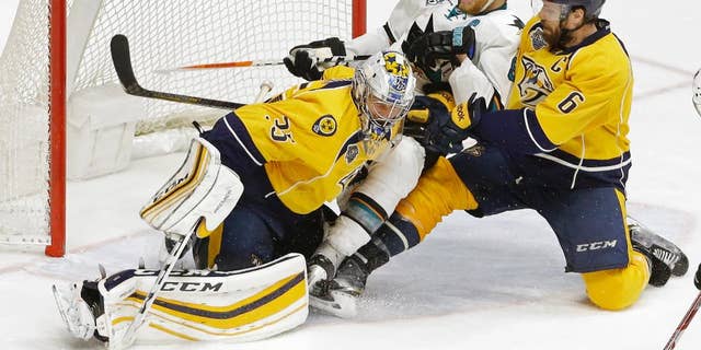 San Jose Sharks center Joe Pavelski (8) and Nashville Predators defenseman Shea Weber (6) slide into Predators goalie Pekka Rinne (35), of Finland, during the second overtime period in Game 4 of an NHL hockey Stanley Cup Western Conference semifinal playoff series Friday, May 6, 2016, in Nashville, Tenn. (AP Photo/Mark Humphrey)