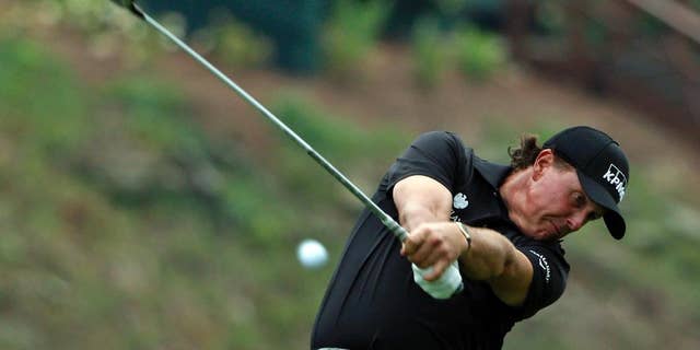 Phil Mickelson hits his tee shot on the 15th hole during the second round of the PGA Championship golf tournament at Valhalla Golf Club on Friday, Aug. 8, 2014, in Louisville, Ky. (AP Photo/Mike Groll)