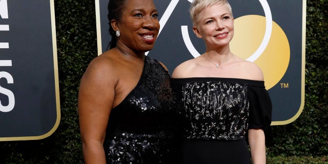 Tarana Burke (L) and Michelle Williams arrive at the 75th Golden Globe Awards in Beverly Hills, Calif., Jan. 7, 2018.