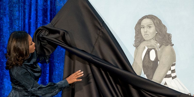 Former first lady Michelle Obama unveils her portrait at the Smithsonian's National Portrait Gallery.