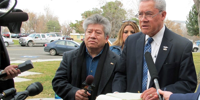 Activist Felix Vargas, right, talks with reporters, Wednesday, Feb. 25, 2015.