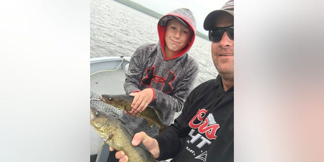 Kevin Wayne Sharp poses with his son, Sterling Wayne Sharp, on a boat at Poplar Point Resort, in Red Lake, Ontario, Canada in this picture uploaded to Facebook on July 22, 2017. Kevin Sharp via REUTERS ATTENTION EDITORS - THIS IMAGE WAS PROVIDED BY A THIRD PARTY. NO RESALES. NO ARCHIVES. MANDATORY CREDIT: KEVIN SHARP - RC1B28491530