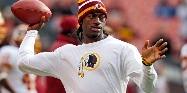 Washington Redskins quarterback Robert Griffin III tosses a ball during warmups before an NFL football game against the Cleveland Browns in Cleveland, Sunday, Dec. 16, 2012. Kirk Cousins will start in place of Griffin wgho is sitting out with a sprained knee. (AP Photo/Rick Osentoski)