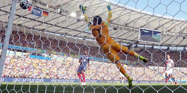 France's goalkeeper Hugo Lloris fails to stop a shot by Germany's Mats Hummels as he scored his side's first goal during the World Cup quarterfinal soccer match between Germany and France at the Maracana Stadium in Rio de Janeiro, Brazil, Friday, July 4, 2014. (AP Photo/Matthias Schrader)