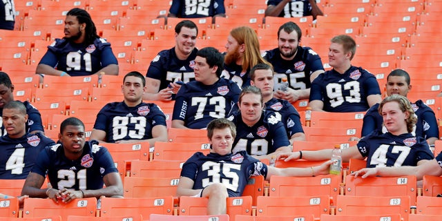 Notre Dame players watch from the stands during Media Day for the BCS National Championship college football game Saturday, Jan. 5, 2013, in Miami. Notre Dame faces Alabama in Monday's championship game.(AP Photo/Chris O'Meara)