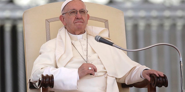 Pope Francis sits during his weekly general audience in St. Peter's Square at the Vatican, Wednesday, May 16, 2018. Pope Francis warned Wednesday that the latest spasm of violence in the Holy Land is only hurting chances for peace, and called for revived efforts at dialogue and justice. (AP Photo/Alessandra Tarantino)