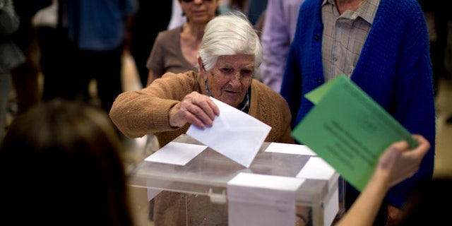 Natividad, 97, casts her vote at a polling station in Barcelona, Spain, Sunday, May 24, 2015. Voters began casting their ballots across much of Spain early Sunday in local elections that could see two upstart parties end ntarly four decades of dominance by the conservative Popular Party and the center-left Socialists. (AP Photo/Emilio Morenatti)