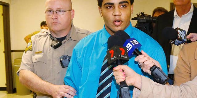 FILE - In this April 17, 2015 file photo, Chancey Luna answers a question for the media as he is led from the courthouse to the jail after being convicted in the death of Christopher Lane in Duncan, Okla. An Oklahoma appeals court on Friday, Dec. 2, 2016, ordered a new sentencing for Luna who has been serving a life in prison without parole term for the fatal shooting of Lane, an Australian baseball player three years ago. (AP Photo/Sue Ogrocki File)