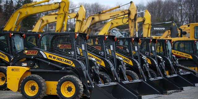 In this Friday, March 28, 2014 photo, earth-moving and construction equipment is stored on a lot at the Highway Equipment Company in Zelienople, Pa. The Commerce Department releases business inventories for March on Tuesday, May 13, 2014. (AP Photo/Keith Srakocic)