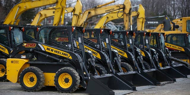 In this Friday, March 28, 2014 photo, earth-moving and construction equipment is stored on a lot at the Highway Equipment Company in Zelienople, Pa. The Commerce Department releases business inventories for March on Tuesday, May 13, 2014. (AP Photo/Keith Srakocic)