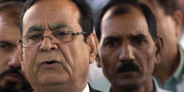 Saiful Malook, left, lawyer of Pakistani Christian woman Aasia Bibi briefs media with Bibi's husband Ashiq Masih outside the Supreme Court in Islamabad, Pakistan. Thursday, Oct. 13, 2016. Pakistan's supreme court has adjourned an appeal from a Christian woman Aasia Bibi who has been on death row on blasphemous charges since 2010 after one of the judges refused to hear the case citing a possible conflict of interest. (AP Photo/B.K. Bangash)