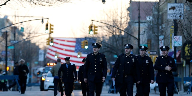NYPD officers attend funeral services for officer Rafael Ramos on Saturday, Dec. 27, 2014, in New York.