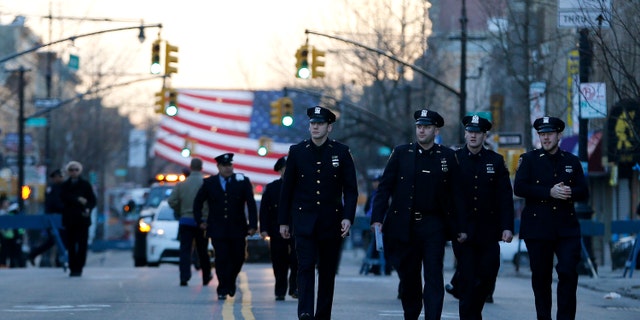 NYPD officers attend funeral services for officer Rafael Ramos on Saturday, Dec. 27, 2014, in New York.
