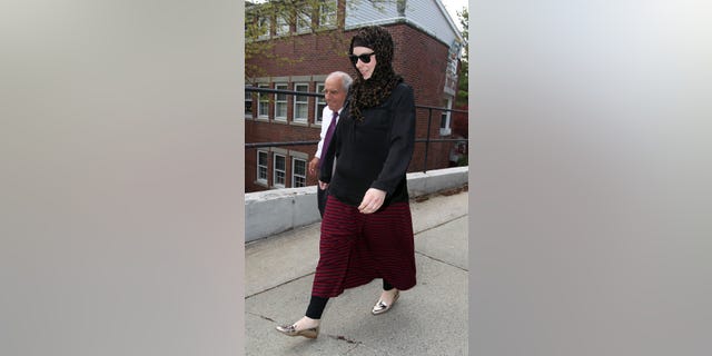 April 29, 2013: Katherine Russell, right, wife of Boston Marathon bomber suspect Tamerlan Tsarnaev, leaves the law office of DeLuca and Weizenbaum with Amato DeLuca, left in Providence, R.I.