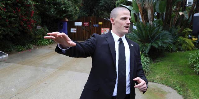 A private security guard tells journalists to cross the street outside the homes of Debbie Reynolds and her daughter Carrie Fisher in Los Angeles, Thursday, Jan. 5, 2017. Reynolds died Dec. 28 at the age of 84, a day after her daughter died at the age of 60. (AP Photo/Reed Saxon)