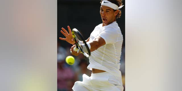 Rafael Nadal of Spain plays a return to Nick Kyrgios of Australia during their men's singles match at the All England Lawn Tennis Championships in Wimbledon, London, Tuesday July 1, 2014. (AP Photo/Ben Curtis)
